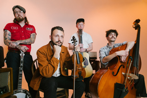 Taff Rapids image. A promotional image of the band with their instruments (banjo, violin, guitar, double bass).