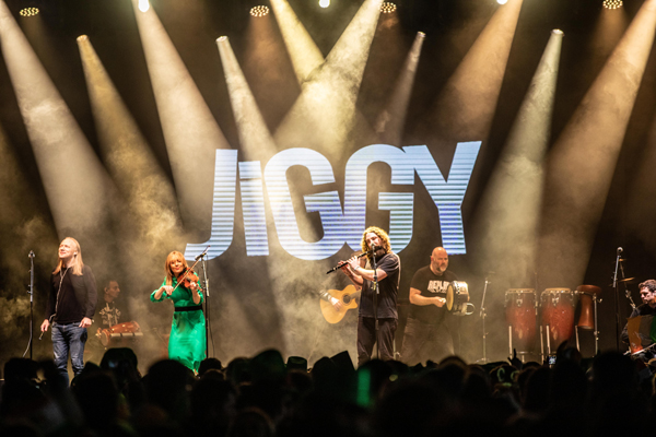 Jiggy image. The band are on stage performing live. 