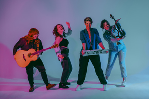 RE:VULVA image. The 4 band members are posing for the picture with their instruments. They are indoors with a plain white background. They are lit by blue and purple lighting.